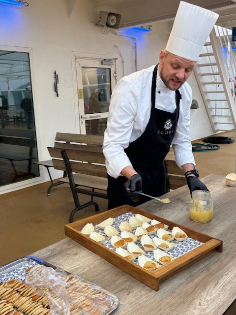 Chef Sivert Ouerli concocts pancakes with apple compost on the top deck of the MS Trollfjord