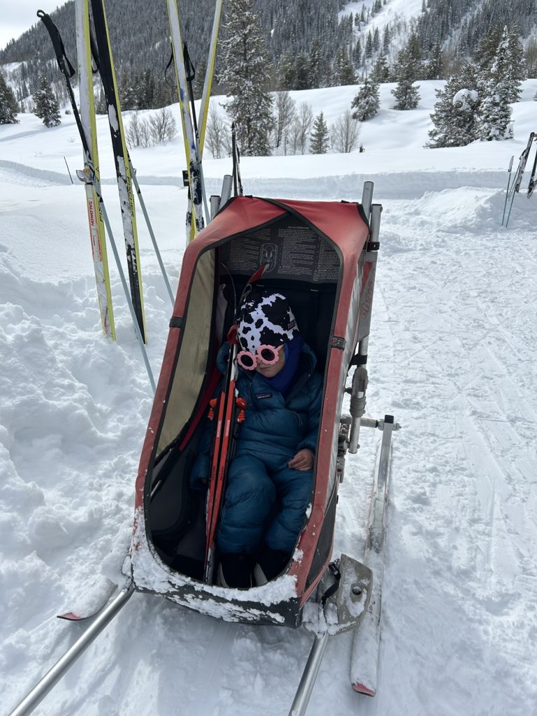 A toddler all tuckered out from an X-country outting with her dad in Crested Butte CO