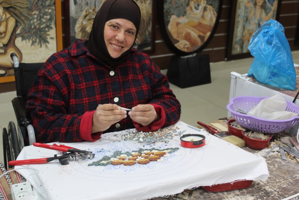 One of the women painstakingly piecing together mosaics in the Queen Noor Foundation Workshop near Mount Nebo in Jordan