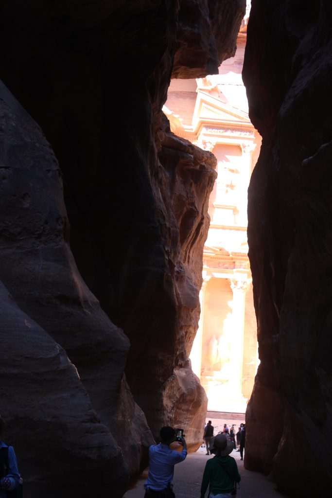 First glimpse of the "Treasury" in Petra Jordan, walking in through a narrow canyon