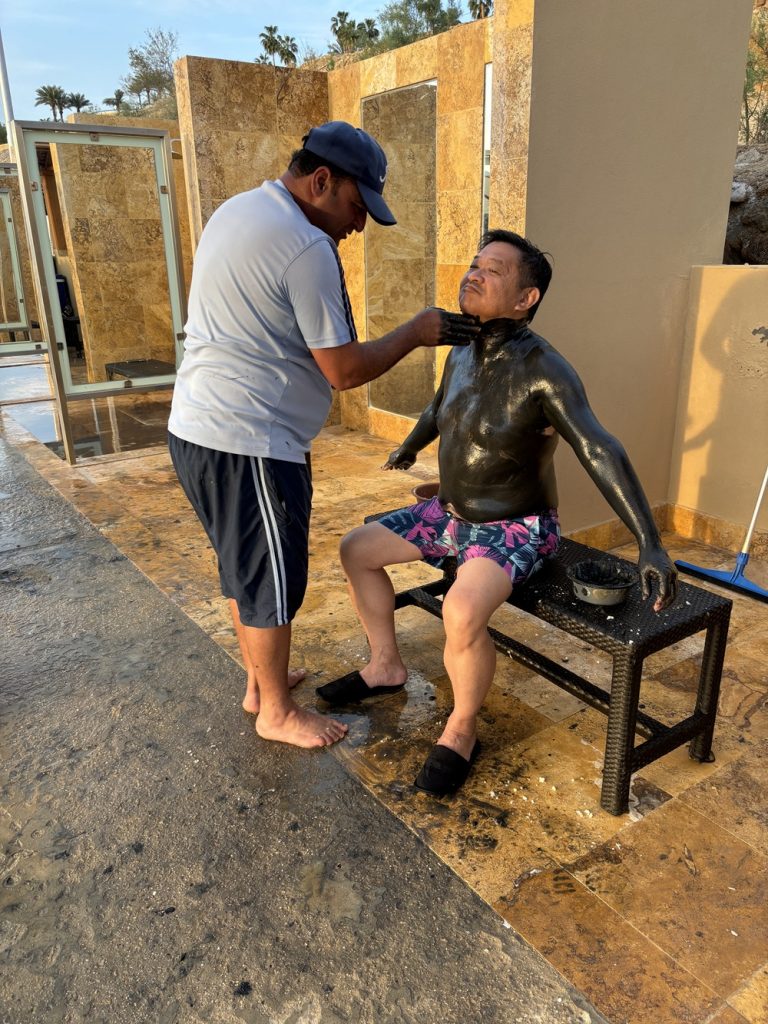 Kempinski staff applying mud to guests shore of The Dead Sea (photos by Andy Yemma)