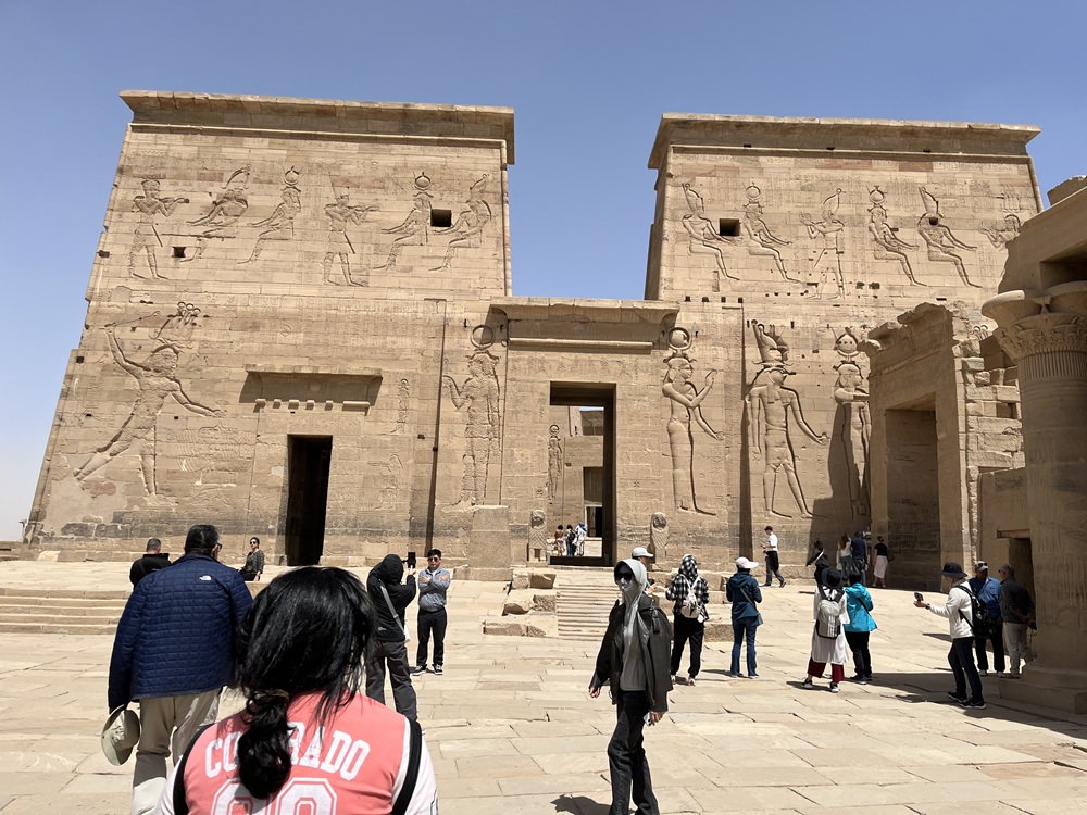 At the Temple of Philae, ancient carvings (left) were defaced by Greeks and other religions, while left intact on the right