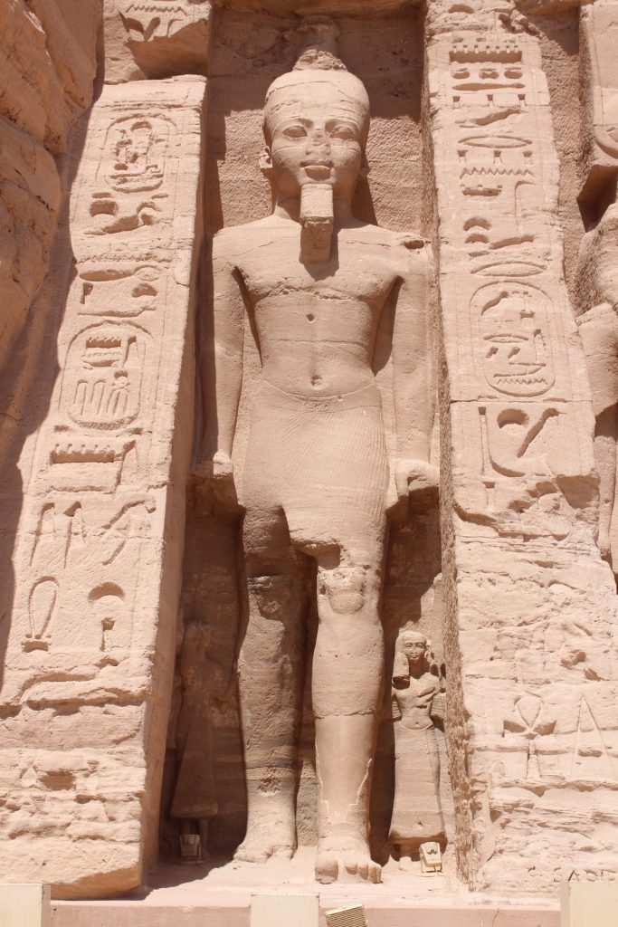 Statue of Ramses II at the temple he built for his wife Queen Nefertari, whose statue notably a fraction of his size