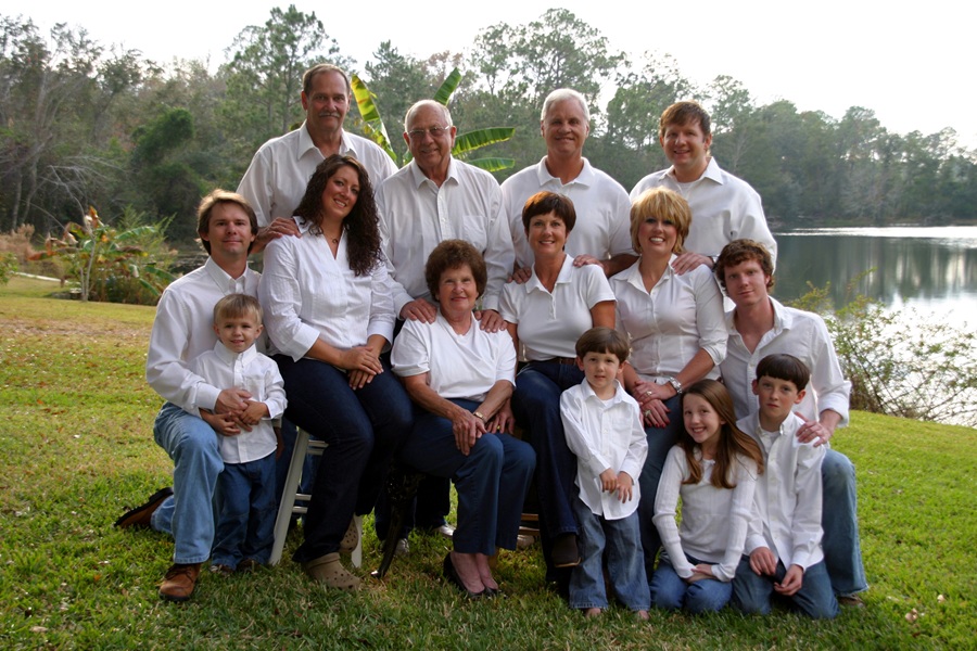 Family reunion. Large family of 14 people in white shirts and denim jeans outside