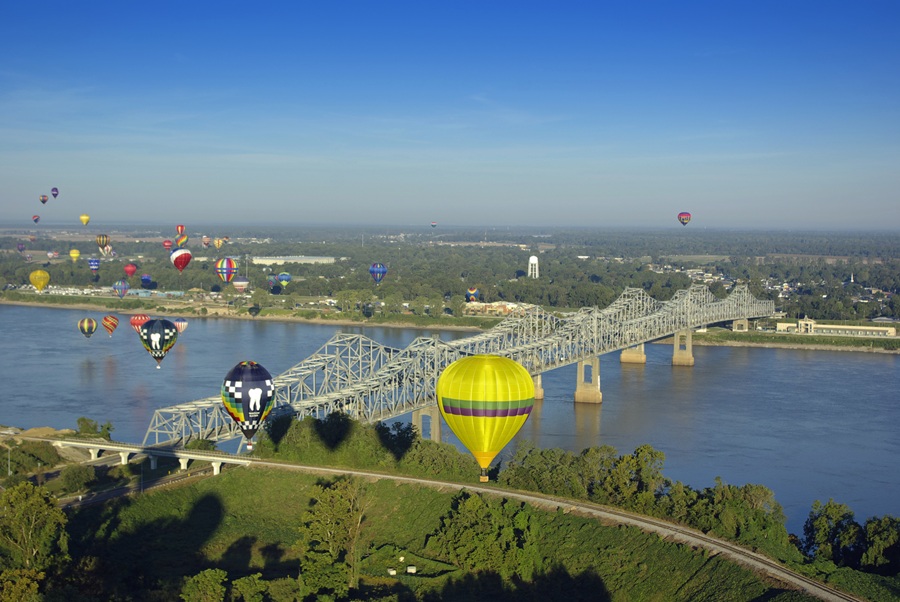 Hot air balloons flying over the Mississippi River toward Louisiana at Natchez, MS