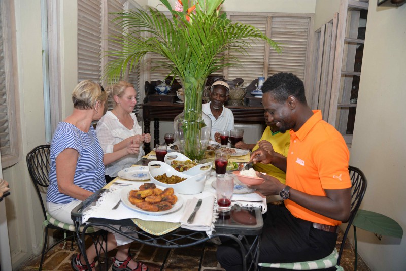 Sharing a meal with locals in Jamaica, as part of the Meet the People program