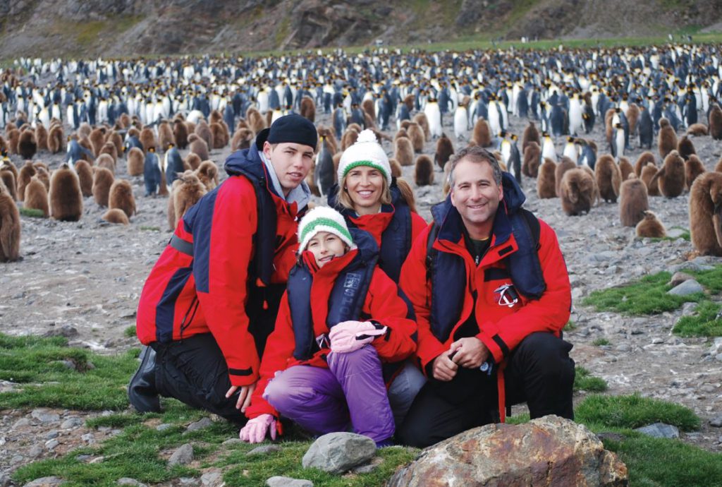 Family and penguins on South Georgia Island