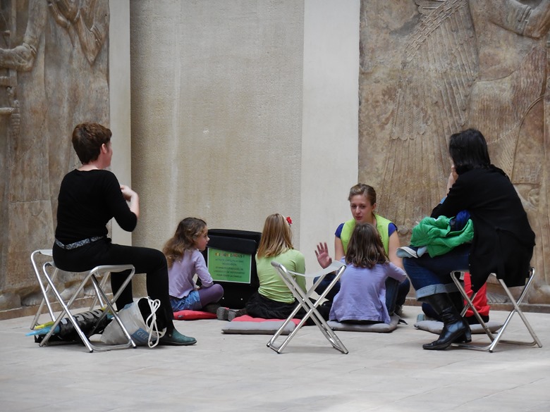 Children getting an art and history lesson from a guide in the Louvre