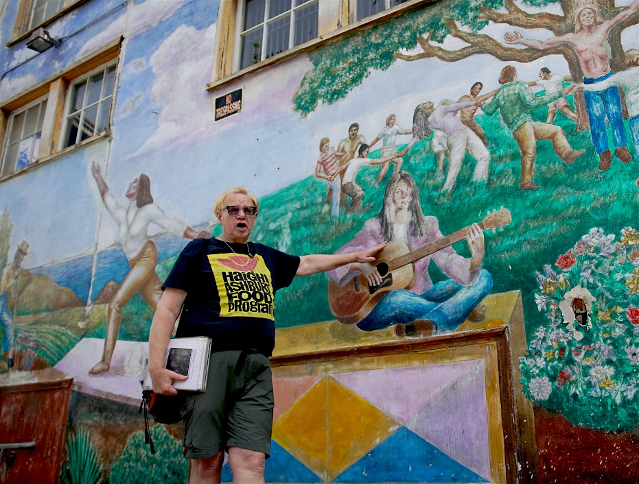 Guide Stan Flouride explains mural depicting Summer of Love in 1967