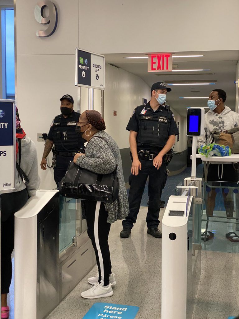 Armed police greet passengers after the THIRD JetBlue aircraft fails to depart