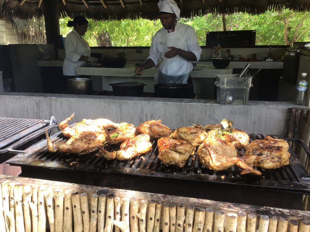 Famous Jamaican Jerk Chicken on the grill at Button Beach