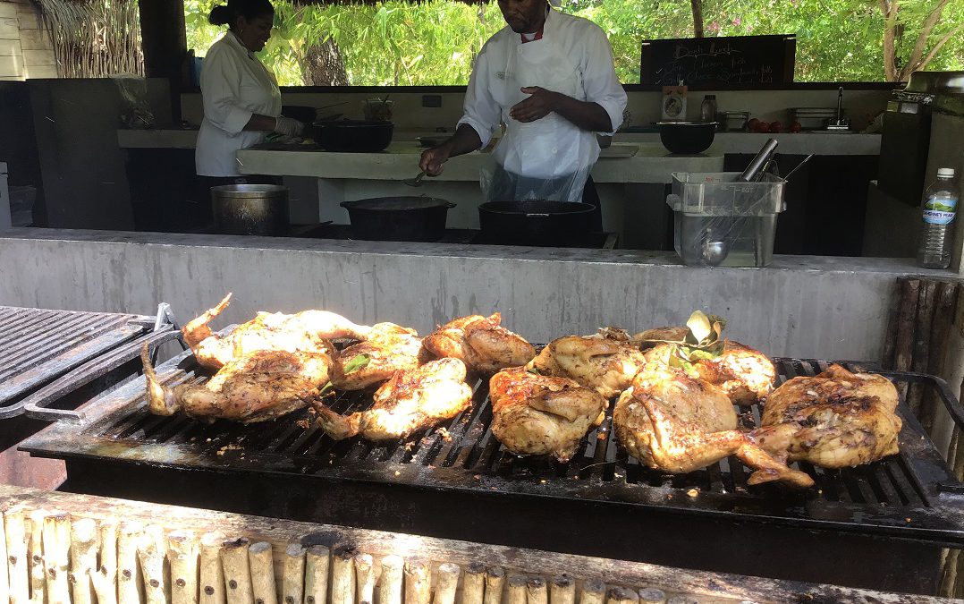Famous Jamaican Jerk Chicken on the grill at Button Beach