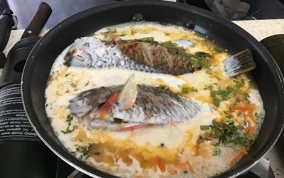 The fish finishing up in the pan of Jamaican curry sauce