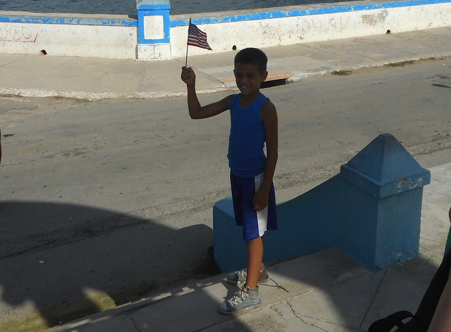 Young Cuban waves American flag in Havana