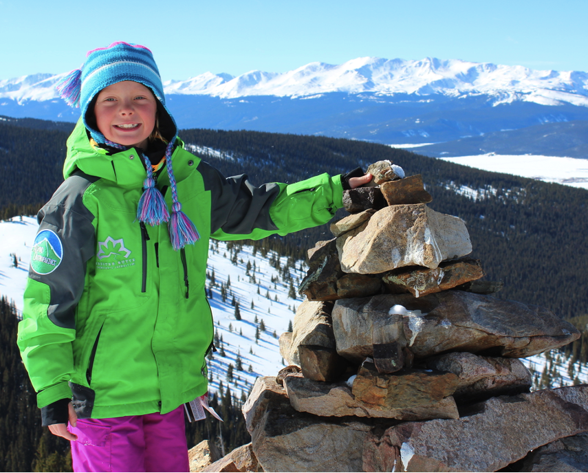 Hazel, 8, adds rock to a cairn originally begun by the 10th Mountain Division during World War II training