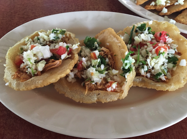 Salbutes (fried corn dough with chicken and diced vegetables) at Benny's Kitchen