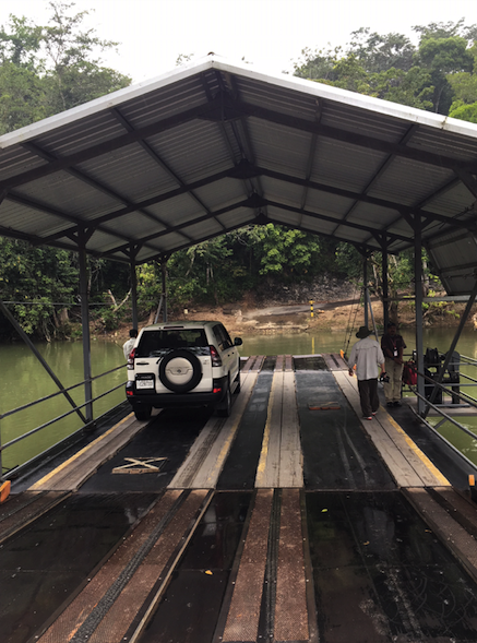 Riding a hand-cranked ferry across river to Xunantunich Maya site in Belize