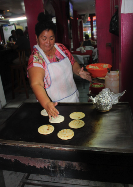 Sara Rodriguez serves up El Salvadoran Pupusas on the Belize Food Tour in San Pedro