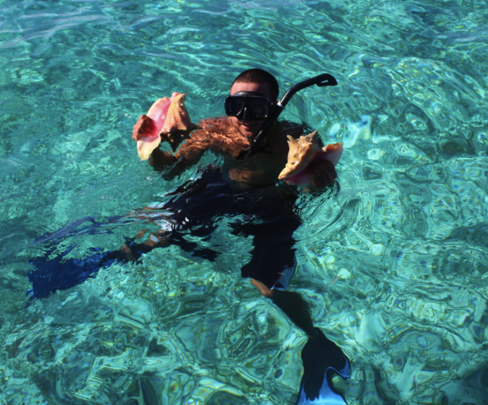 Carlos Cardova produces two nice-sized conch from Belize's barrier reef