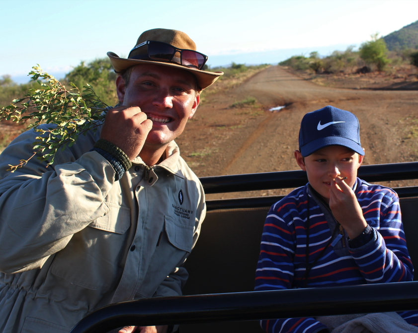 Guide Reuben Johann Grimsell and Jack Frater sampling the "toothpick tree" in Madikwe Game Reserve