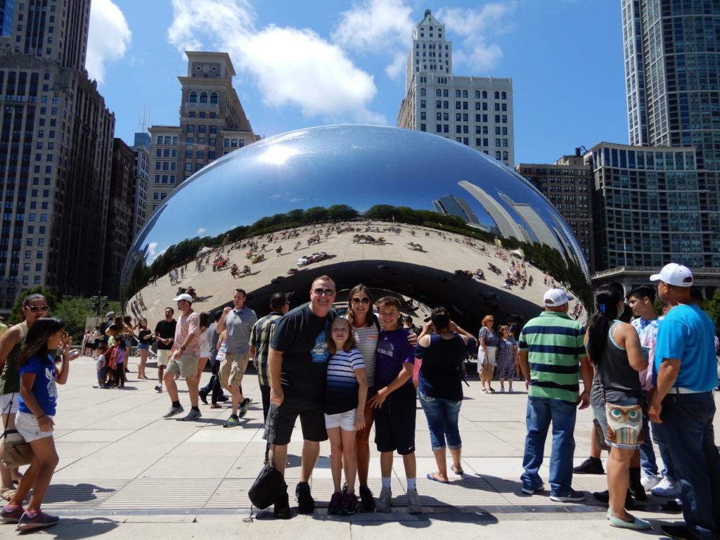 The Sitzman family poses in front of THE BEAN officially known as Cloud Gage