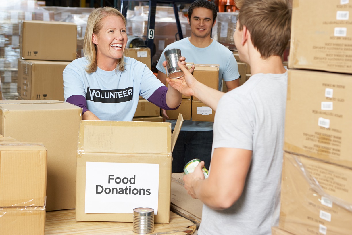 Volunteers collecting food donations in warehouse