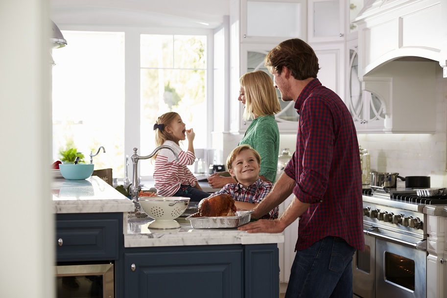 A family enjoying the kitchen in a Homeaway vacation rental