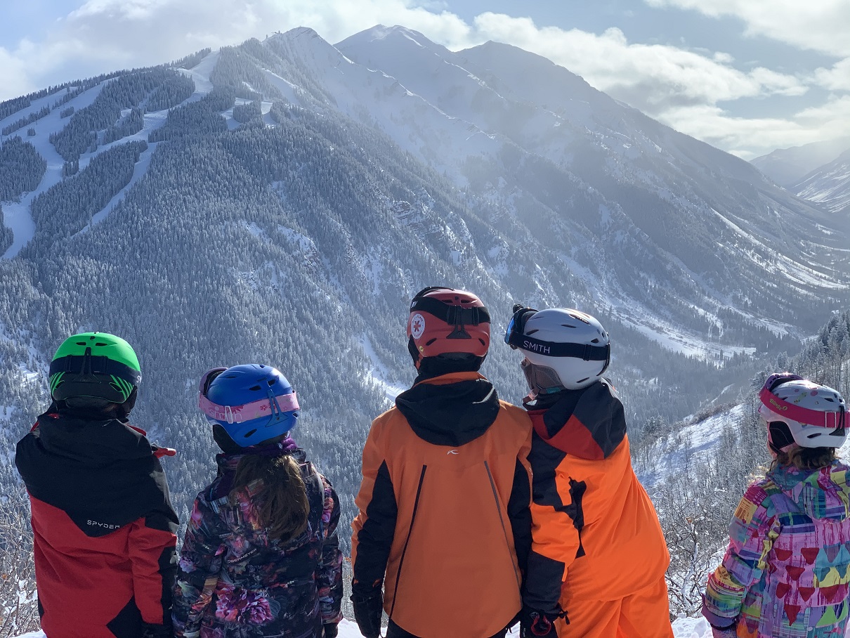 Kids on Buttermilk Mountain looking at nearby Aspen Highlands.