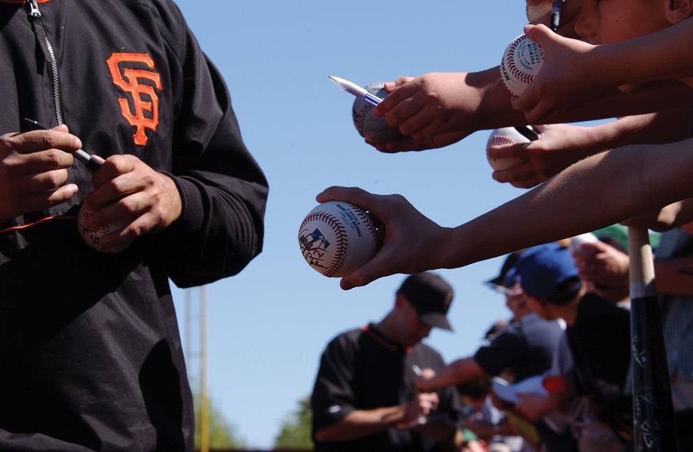 A Giants player signs autographs at Scottsdale Stadium