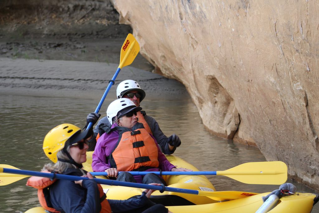 Barb Engbretson, Eileen Ogintz and Layne Lisenbee in kayaks near Yampa Canyon wall
