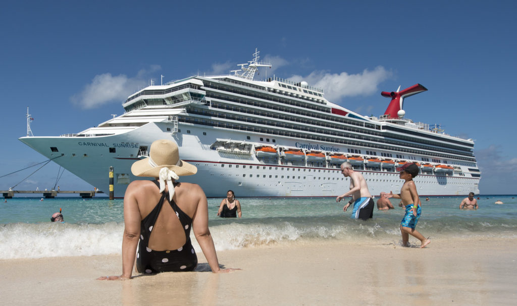 Guests enjoy the beach while the Carnival Sunrise is docked in Grand Turk in the Bahamas