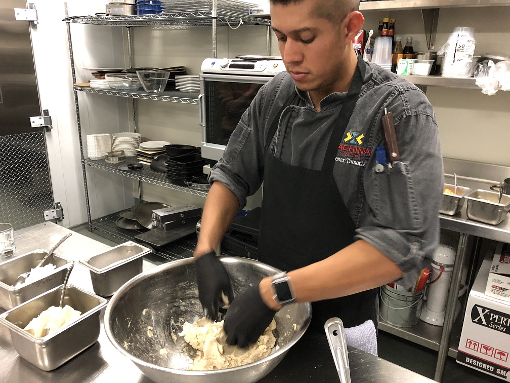 Chef Cesar hand mixes the masa dough for the tamales
