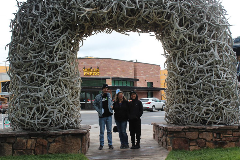 Family from Colorado under the corner arch in Jackson town square