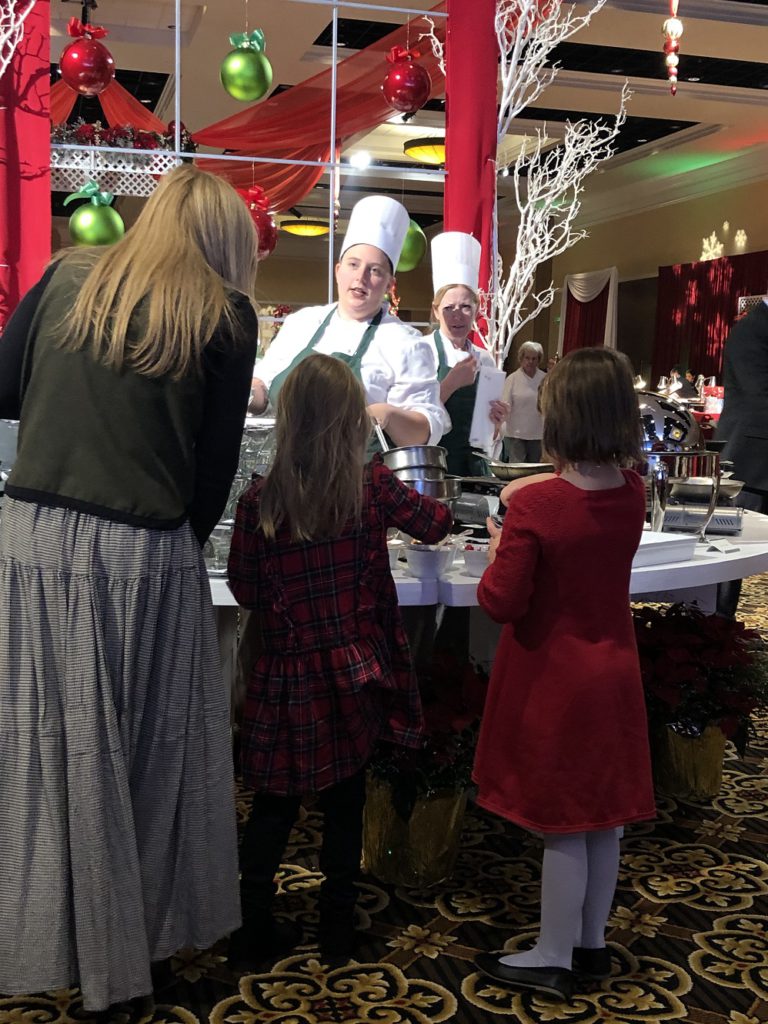 A family decided between crepe suzettes or bananas foster at Broadmoor Christmas Brunch