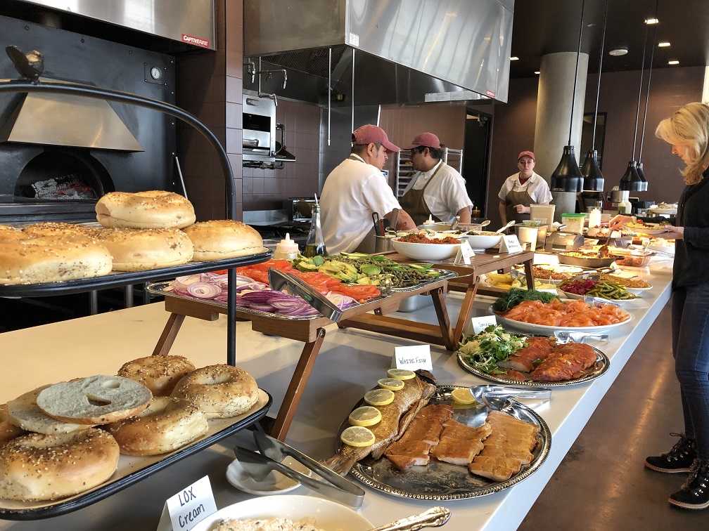 The Sunday brunch buffet line featuring bagels, lox, smoked fish, salads, eggs and much more at Safta in Denver