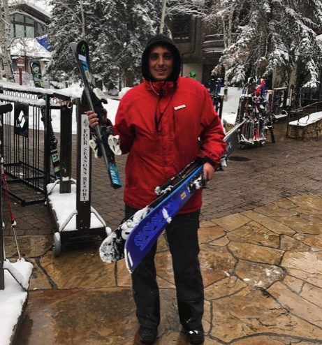 A friendly porter at the Four Seasons ski concierge carries gear to the Gondola