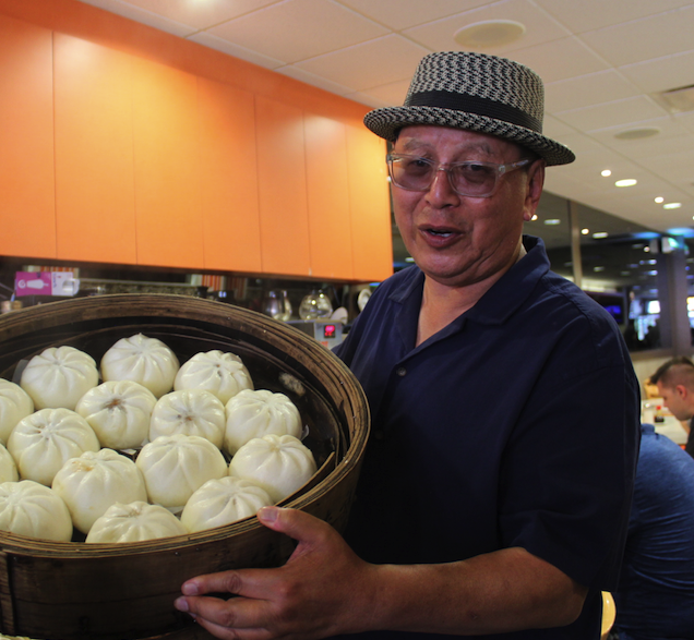 Robert Sung holding pastry balls at New Town Chinese Bakery in Vancouver