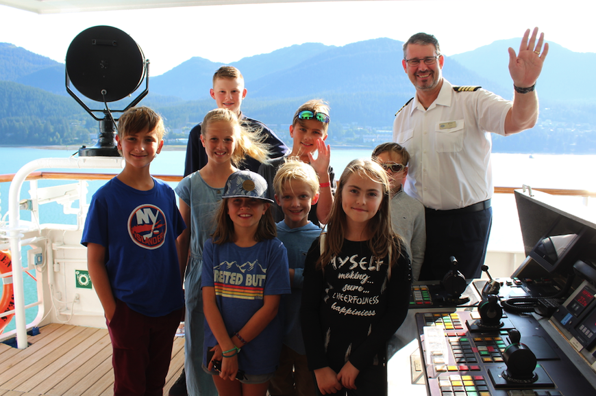 Kids visit the bridge with Captain Palm on the Regent Seven Seas Mariner