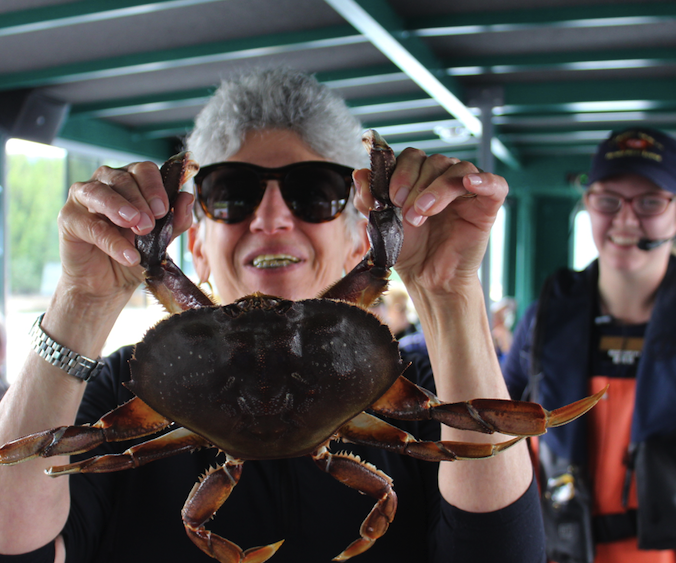 Eileen and a Dungeoness Crab on an excursion near Ketchikan