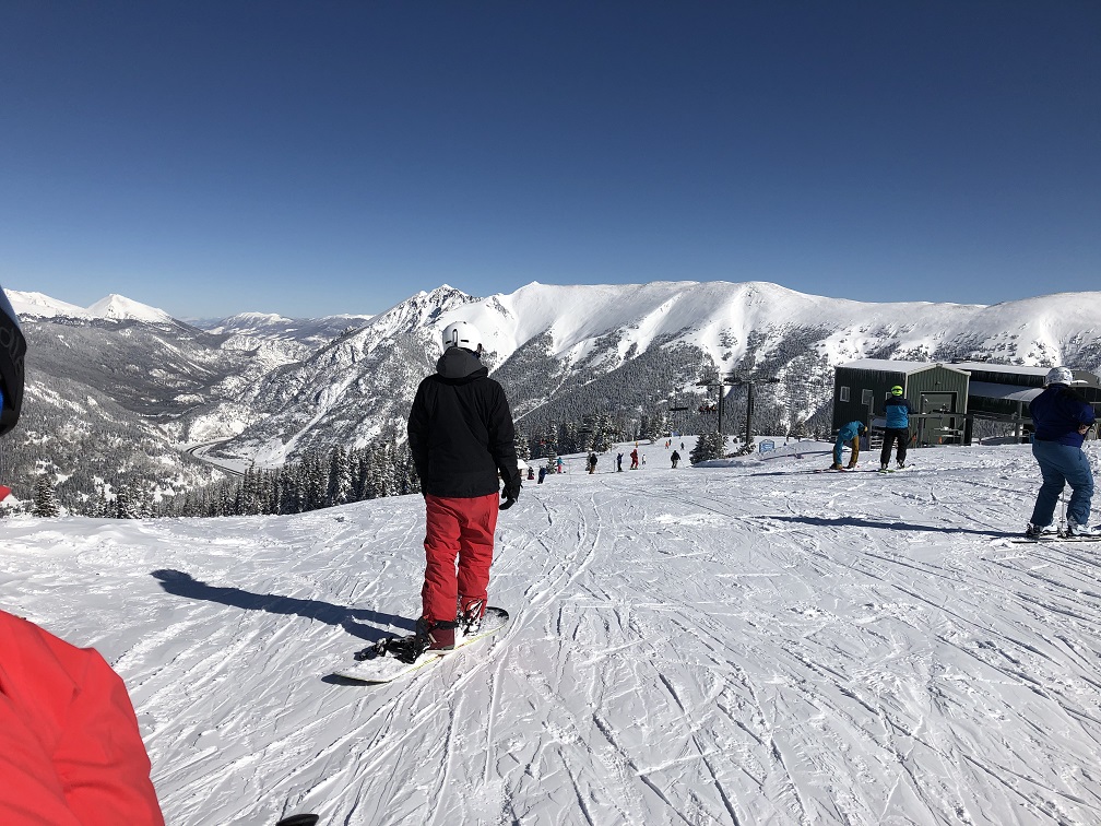 Snowboarder gets ready to carve Copper Mountain on bluebird day