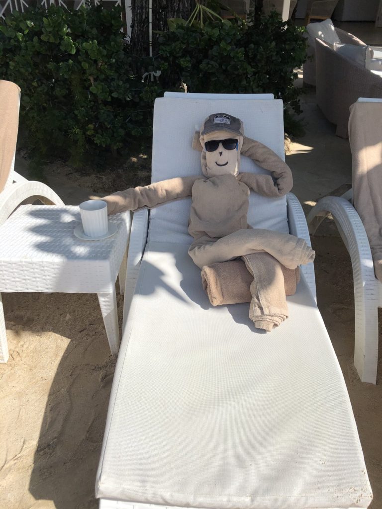 The towel guy lounges on the beach at Sundown Villa