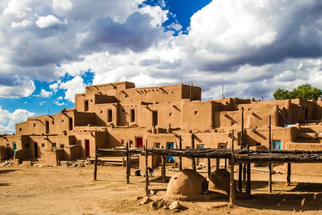 UNESCO World Heritage Site Taos Pueblo With Baking Ovens In Foreground
