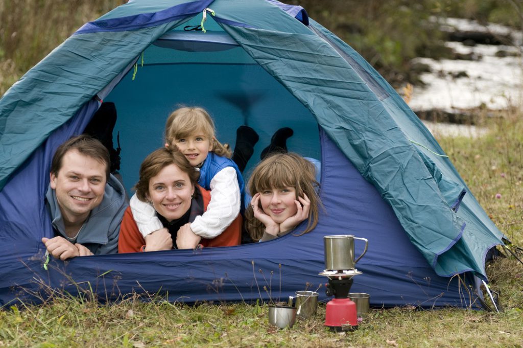 Family camping in tent. (Dreamstime/TNS)