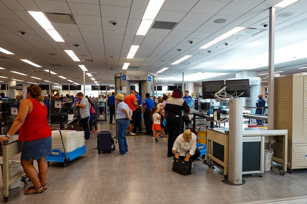 People at a busy airport security at a busy international airport