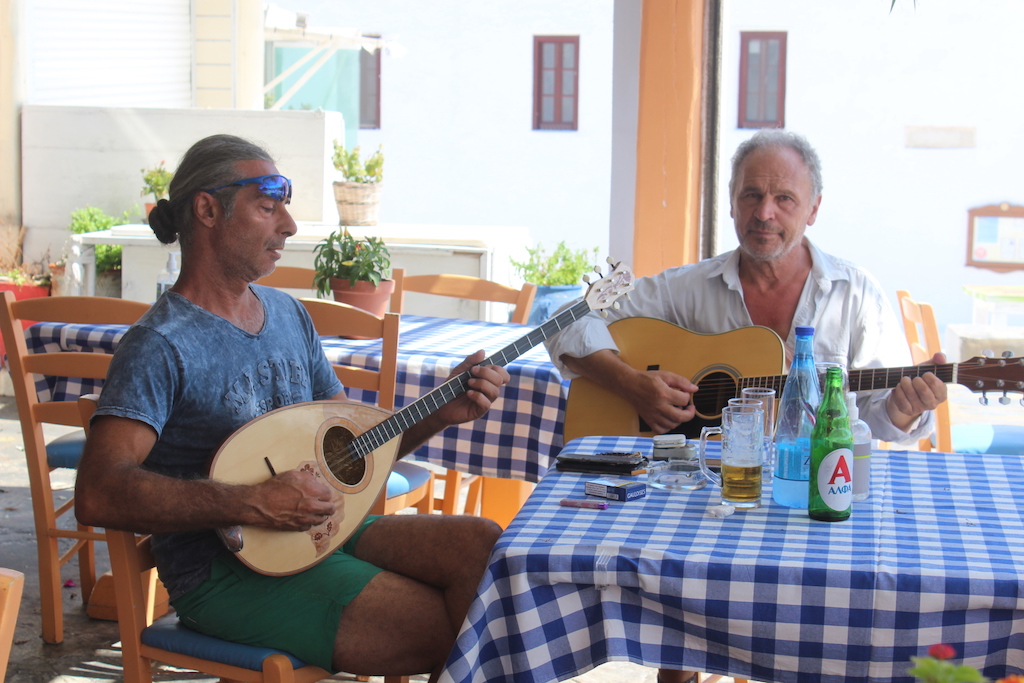 Musicians serenade tourists in a taverna on Mykonos