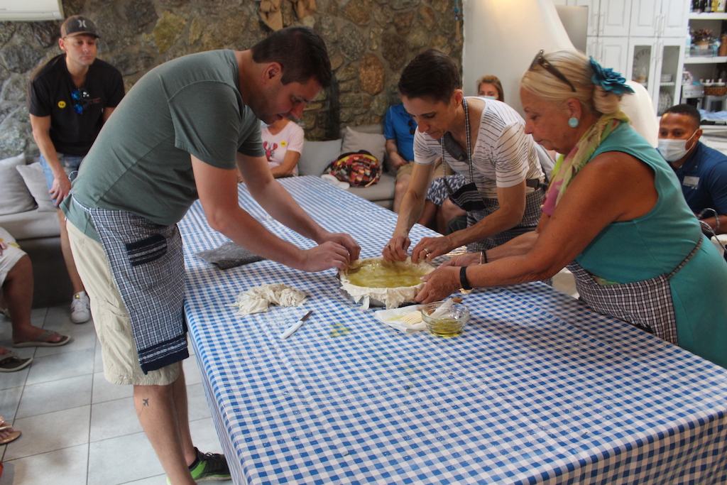 Guests from the Celebrity Apex excursions helping make traditional Greek spinach pie