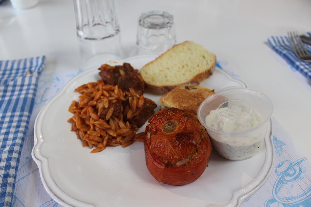 Lunch plate - braised beef and orzo, spinach pie, tzatziki, stuffed tomato, bread and wine