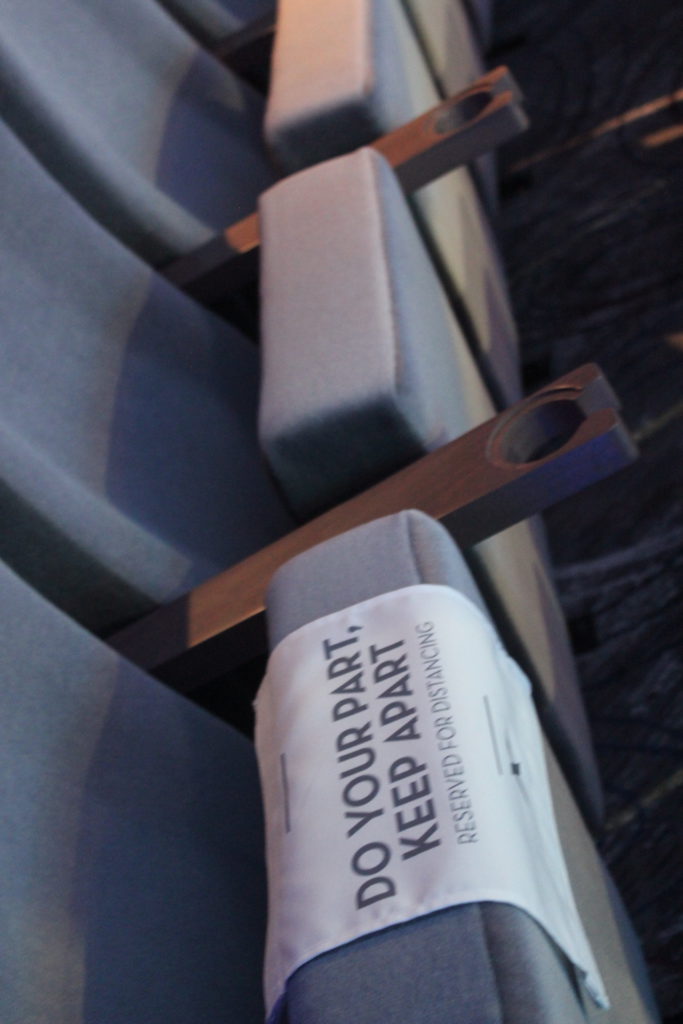 Seats are blocked in the ship's theater to maintain social distancing