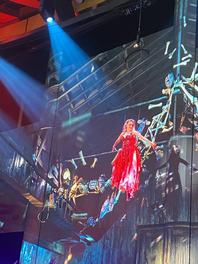 Aerialist in a spooky Halloween performance in the atrium of the Carnival Mardi Gras