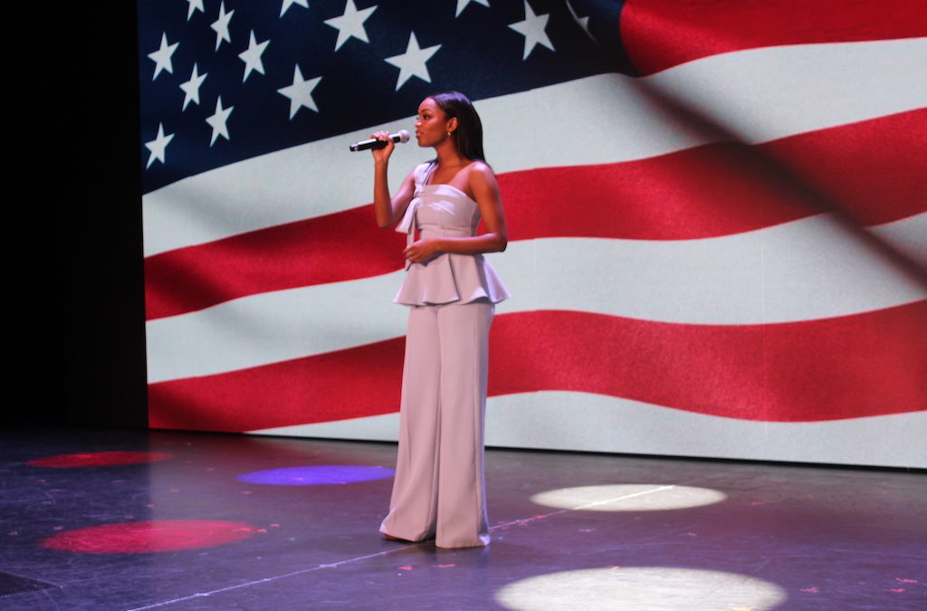 Miss USA Asaya Branch sings the national anthem at the Military Appreciation Tribute aboard the Carnival Mardi Gras